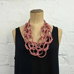 Red Brick rubber necklace on a model with a black dress