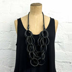Versatile black rubber chain necklace in long drop form