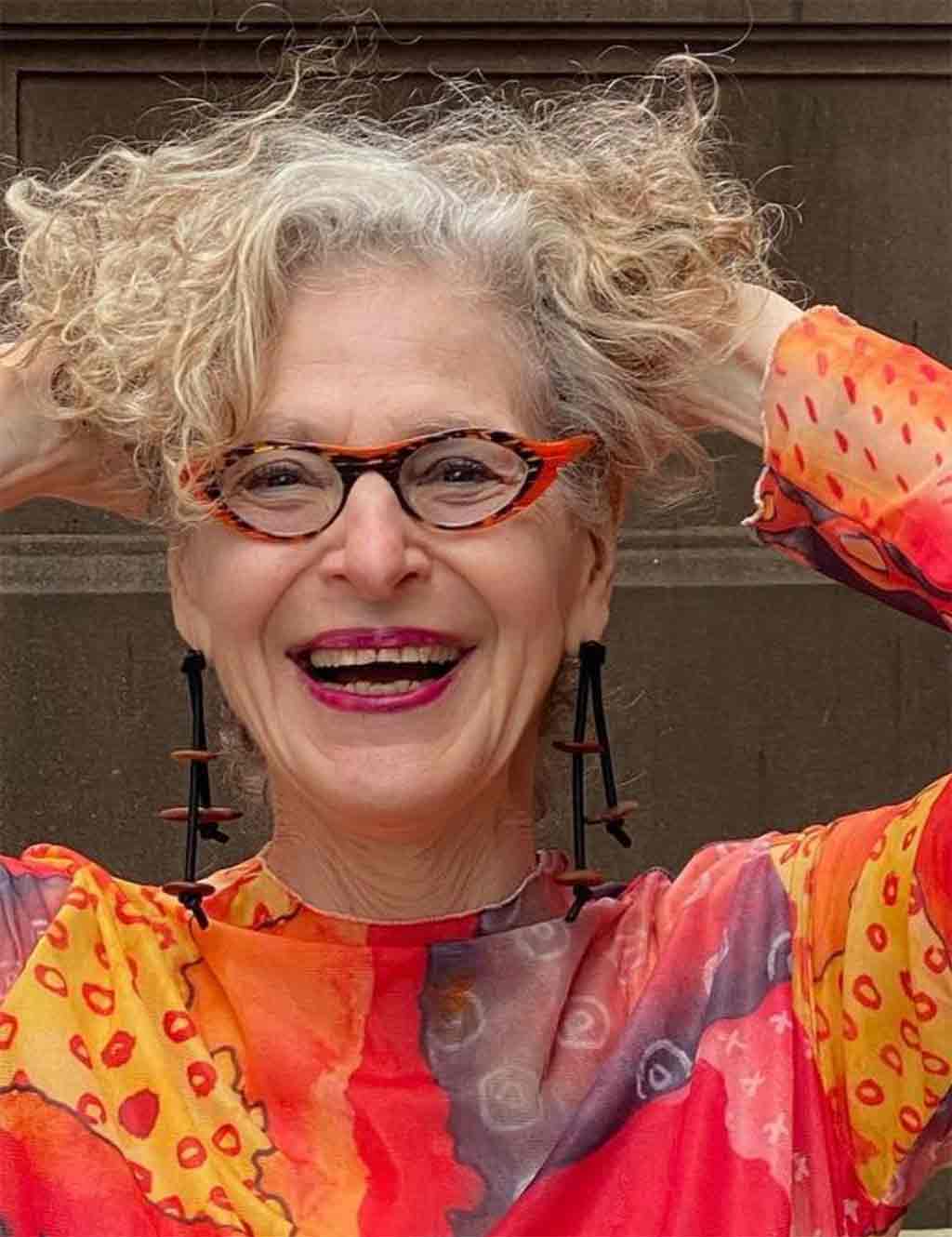 woman wearing a wooden pebble dangling earrings