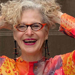 woman wearing a wooden pebble dangling earrings