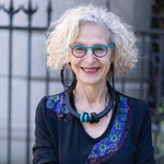woman wearing asymmetric black rubber earrings