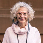 woman wearing a dark teal asymmetric rubber earrings
