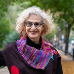 woman wearing asymmetric red rubber earrings