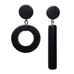 Asymmetrical black dot and dash earrings on a white background