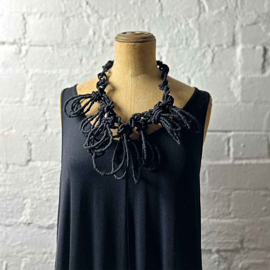 black textile necklace on a mannequin