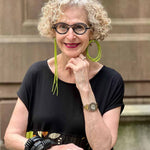 woman wearing asymmetric green rubber earrings