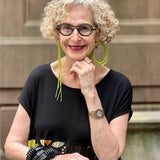woman wearing asymmetric green rubber earrings