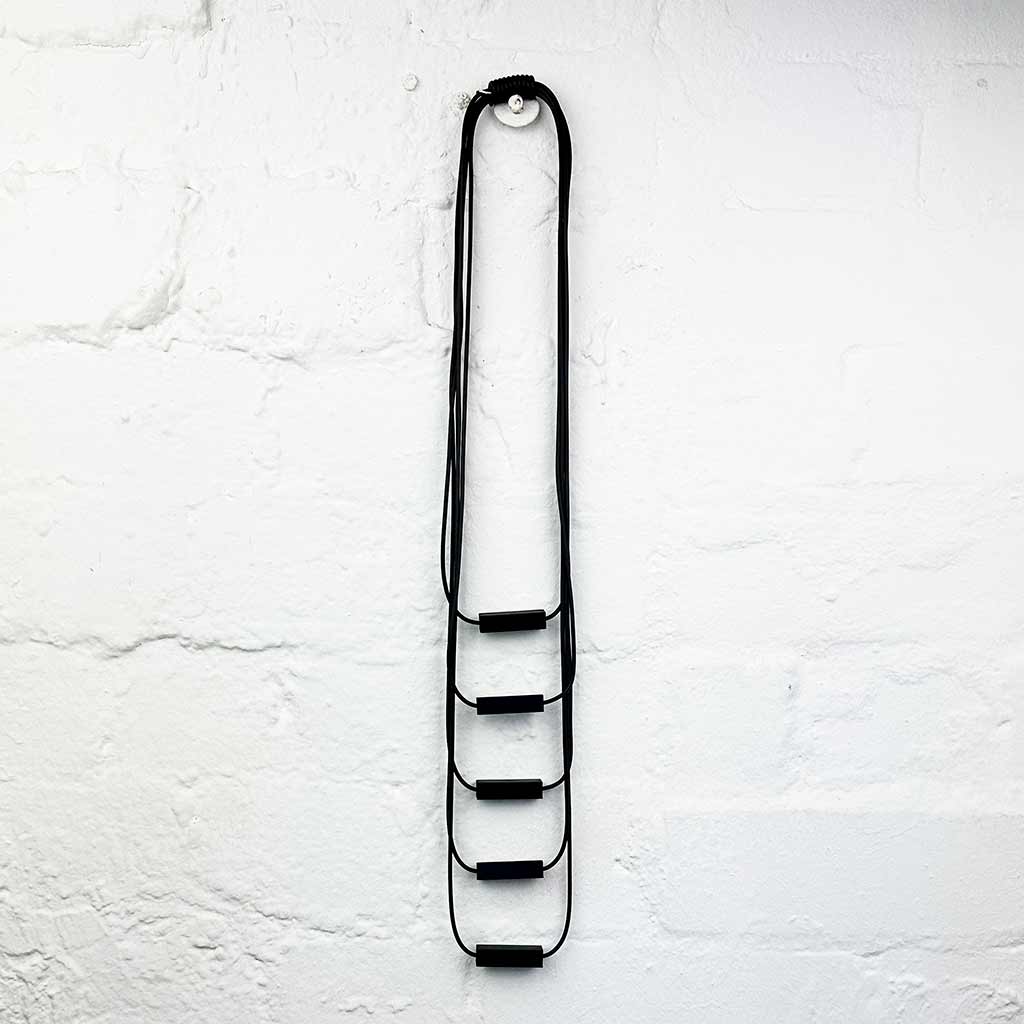 Long drop necklace with black small blocks