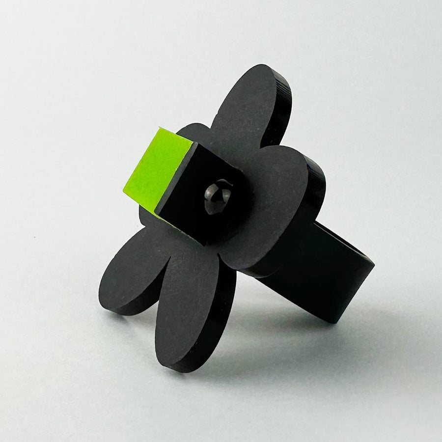 side view of black flower shaped chunky ring