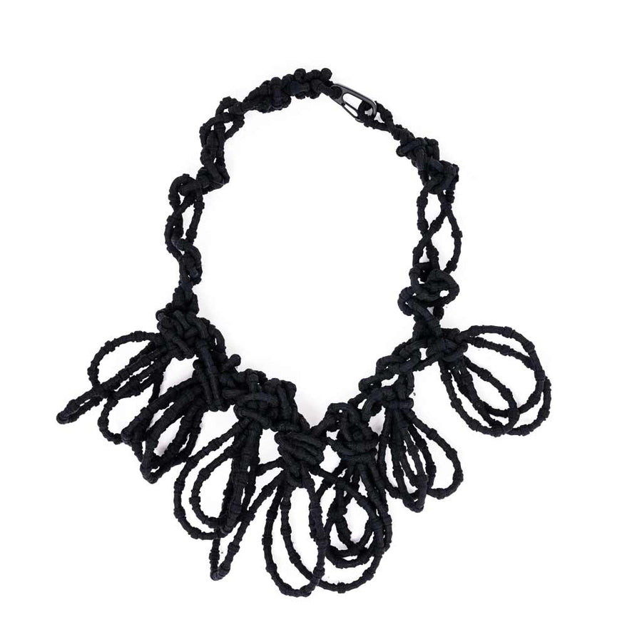 black textile necklace on a white background