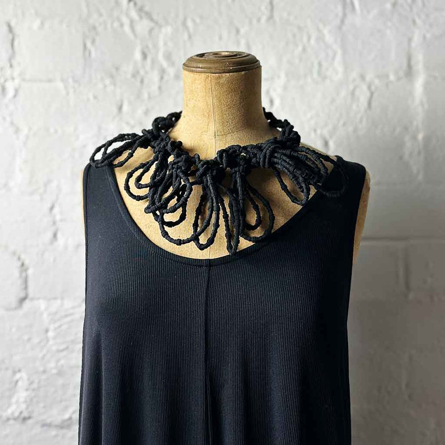 black textile necklace on a mannequin