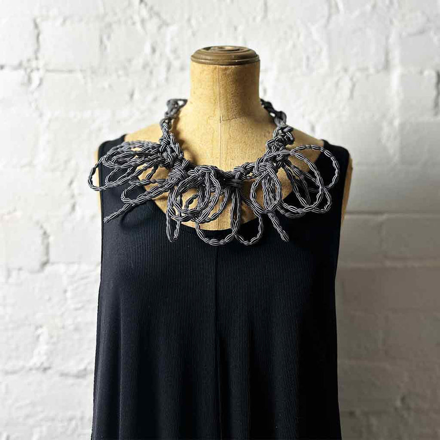 black and white stripe textile necklace on a mannequin