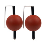 red supersized earrings on a white background