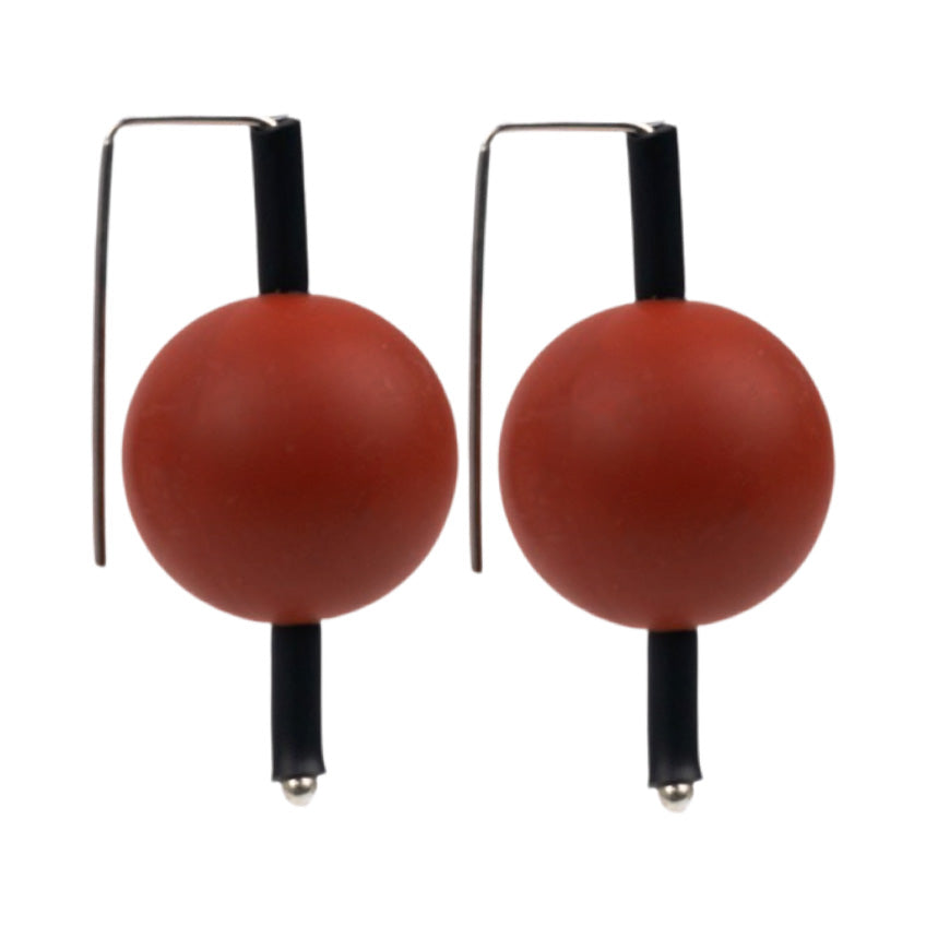 red supersized earrings on a white background