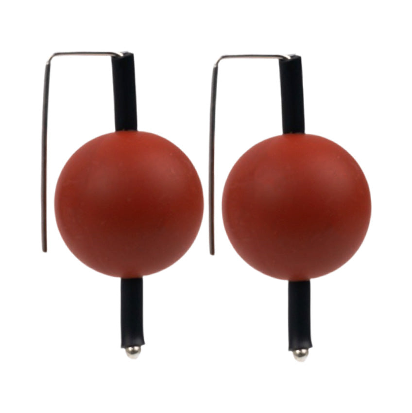 red supersized earrings on a white background