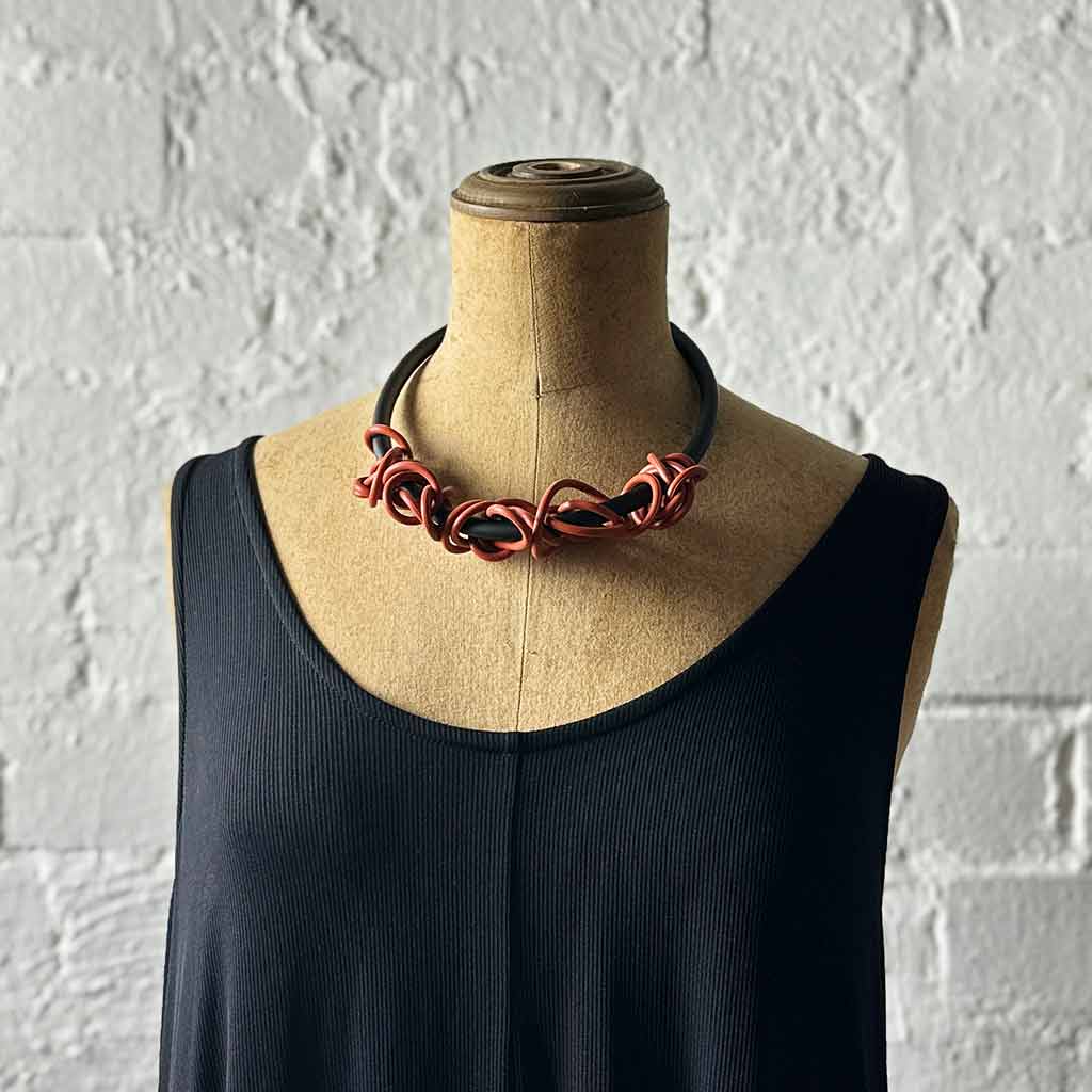 brick-coloured tangled necklace on a mannequin