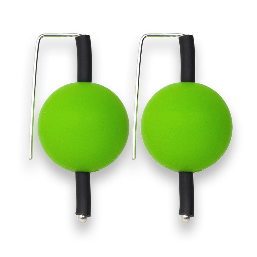 green supersized earrings on a white background