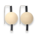 cream-coloured  supersized earrings on a white background