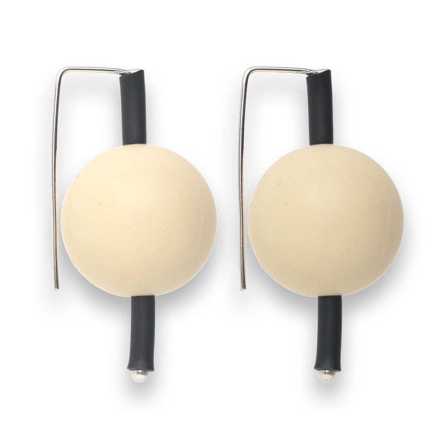 cream-coloured  supersized earrings on a white background