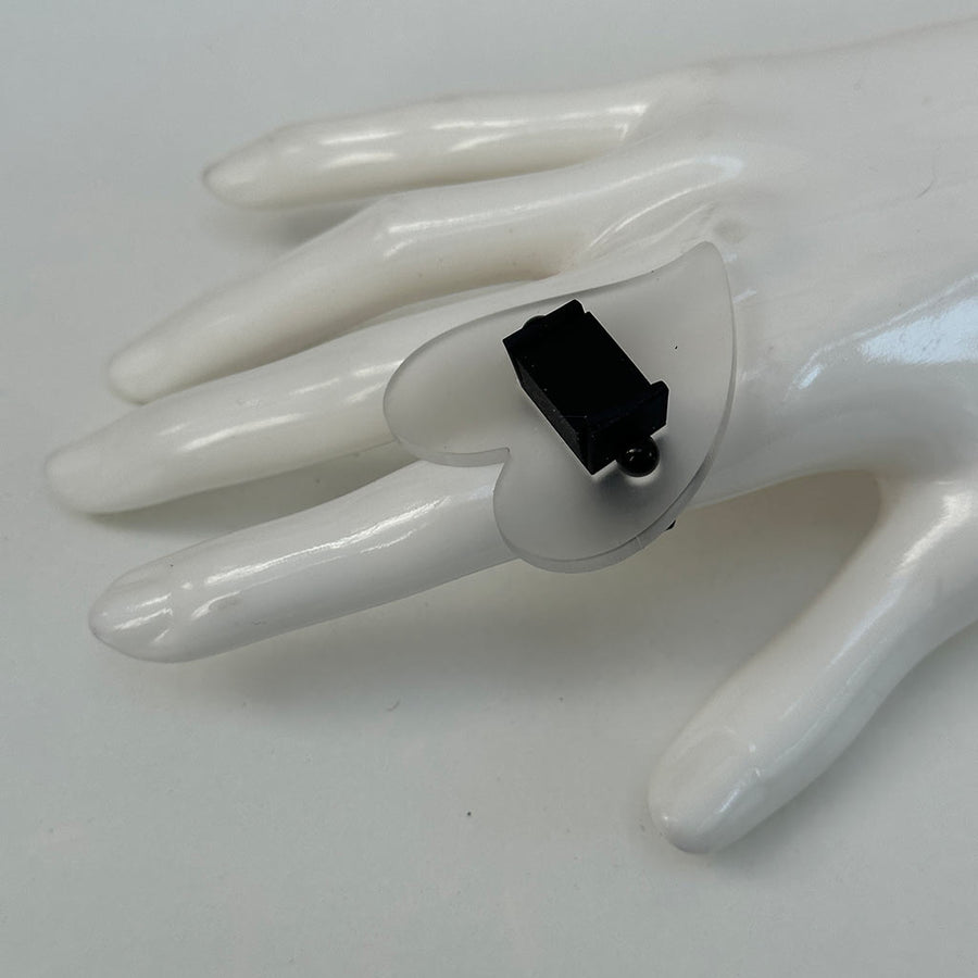 Mannequin hand showcasing clear and black chunky perspex ring