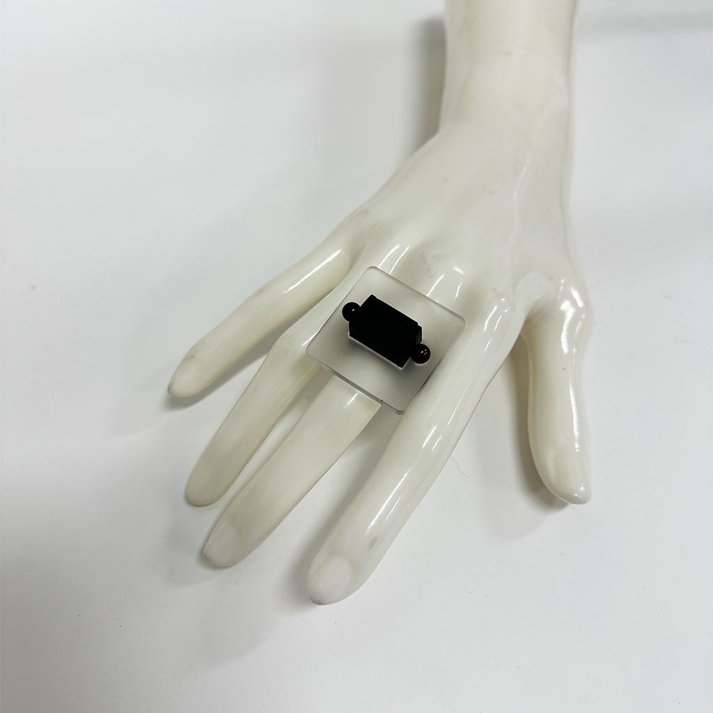 mannequin hand showing a square chunky ring