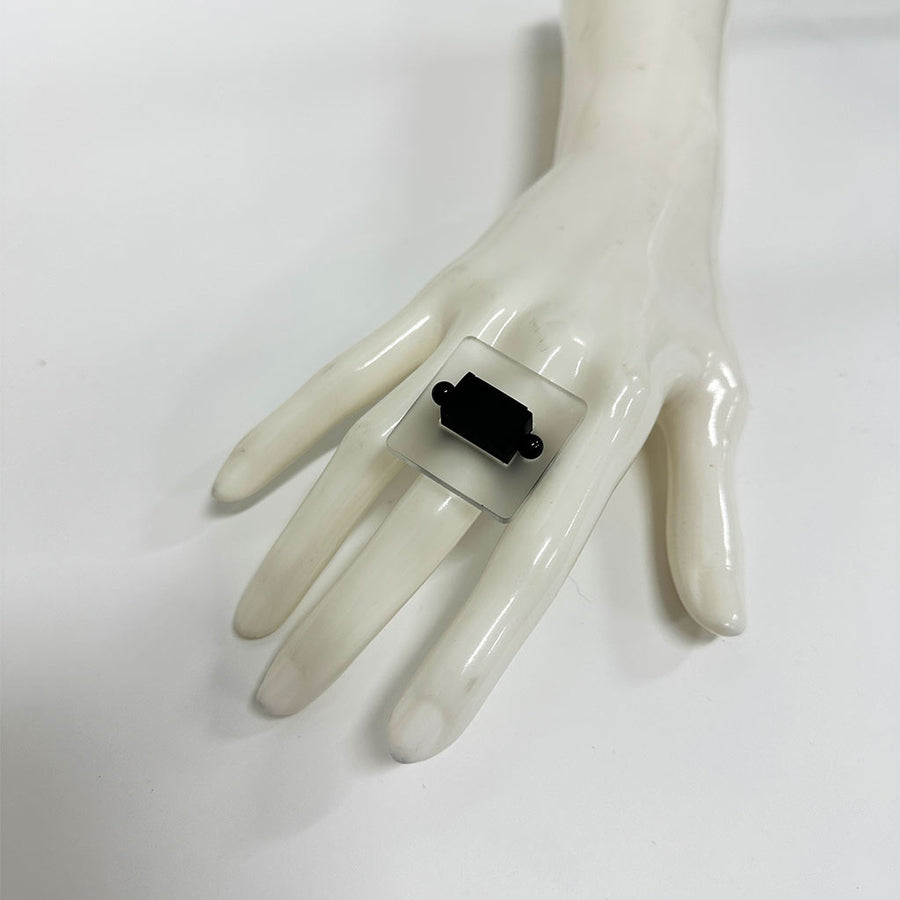 mannequin hand showing a square chunky ring