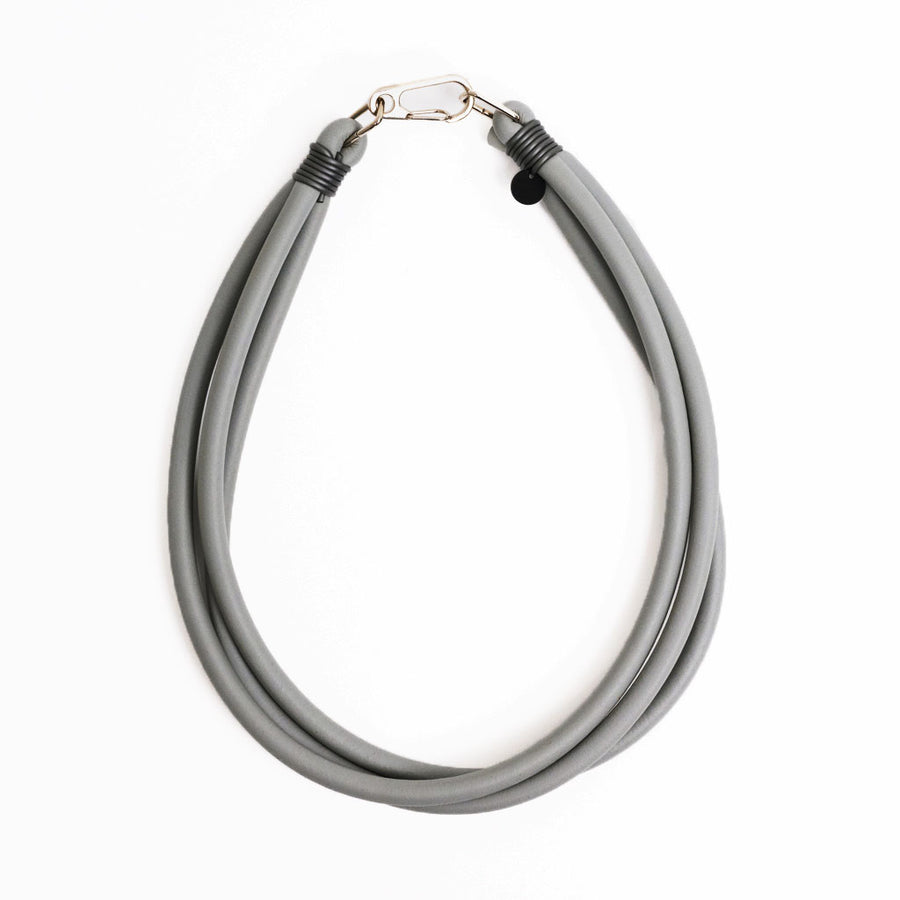 grey triple strand rubber, modern necklace by Frank Ideas on a white background