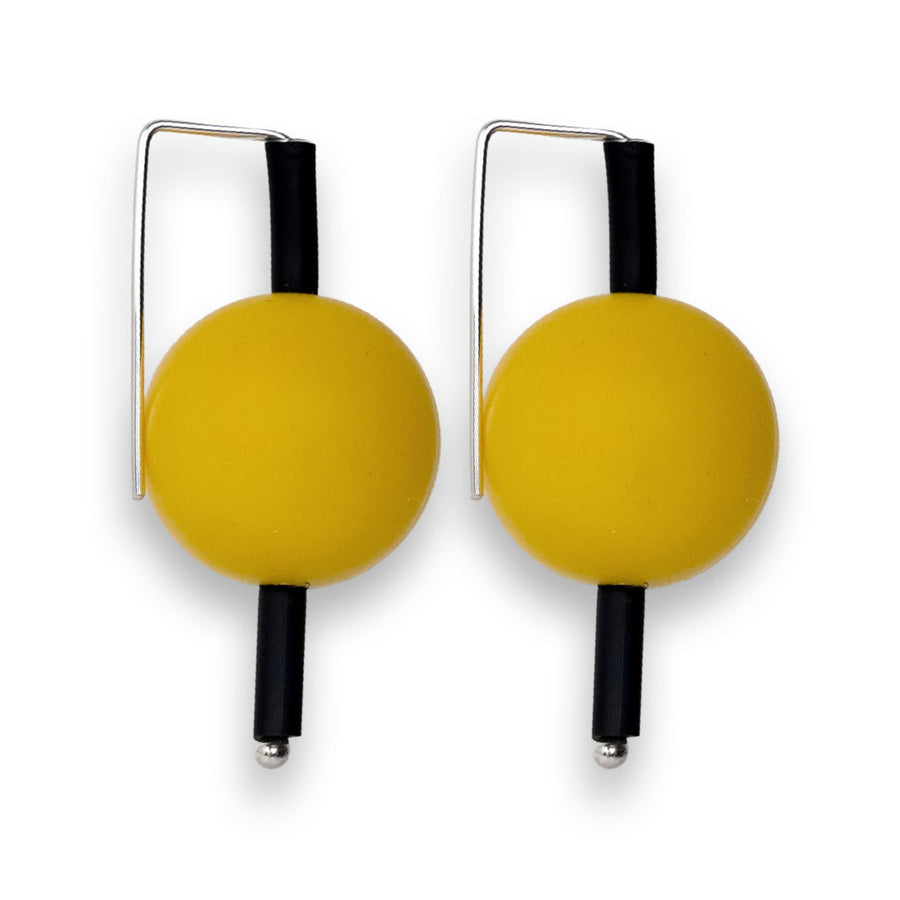 yellow supersized earrings on a white background