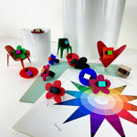 Colorful geometric rings on a color wheel with a white curtain background