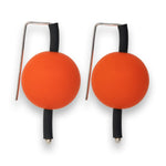 orange supersized earrings on a white background