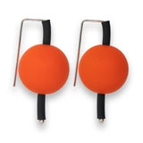 orange supersized earrings on a white background