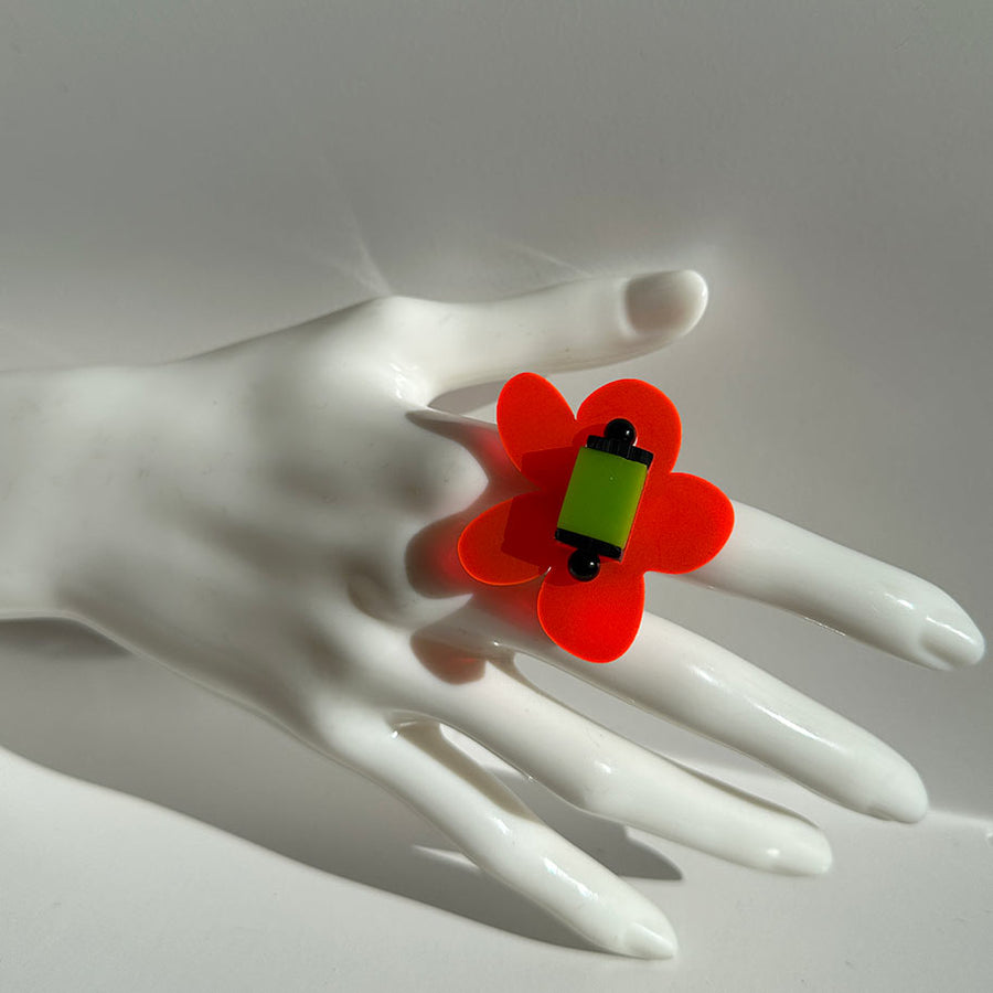Mannequin showing a bright orange and lime green chunky ring