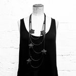 black star necklace on a mannequin