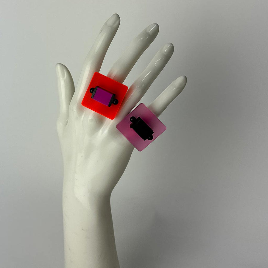 mannequin showing two brightly coloured perspex chunky rings