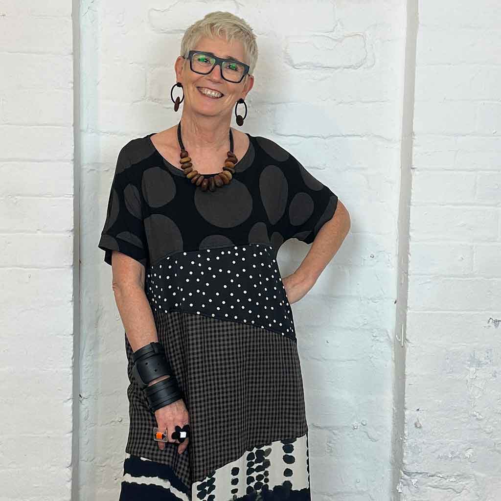 woman wearing a wooden pebble necklace