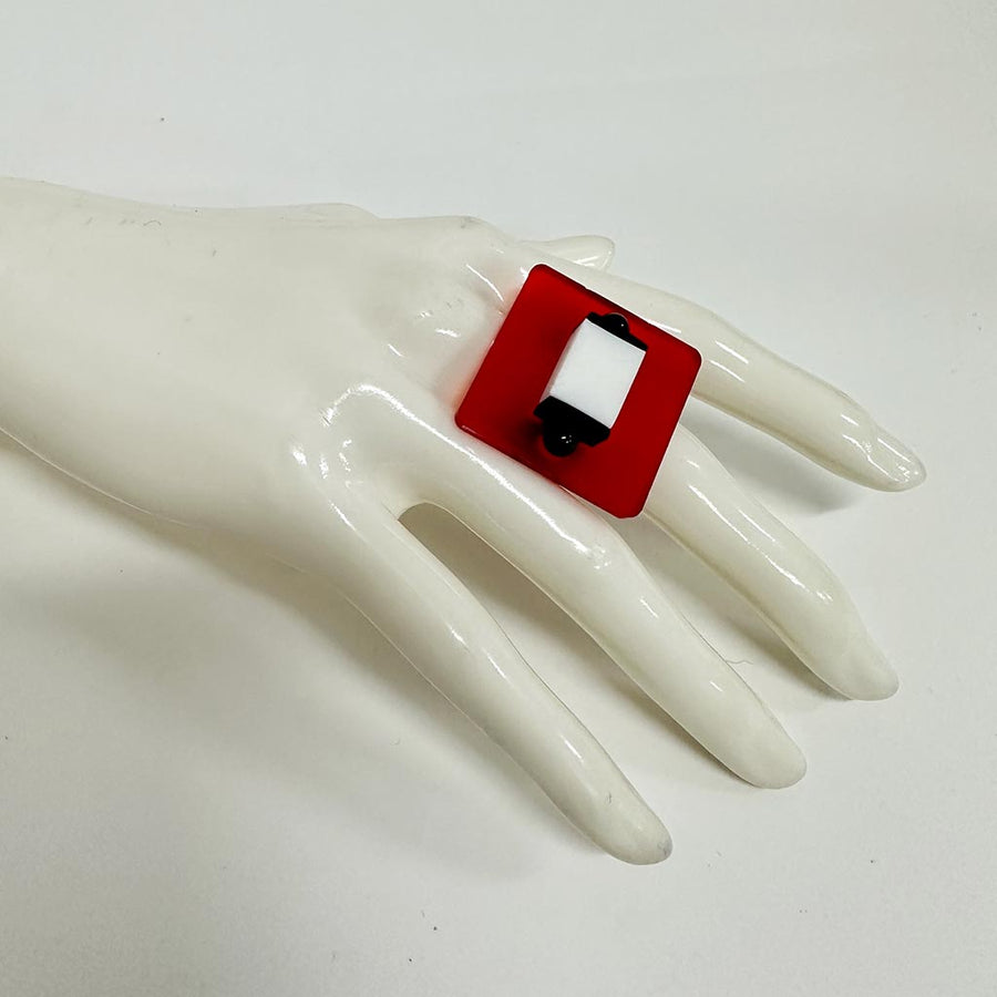 mannequin showing a square red and white chunky ring