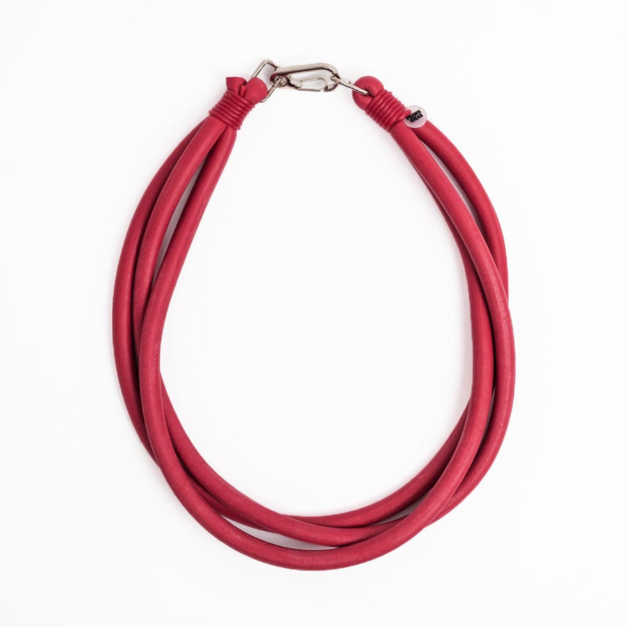 red triple strand rubber, modern necklace by Frank Ideas on a white background