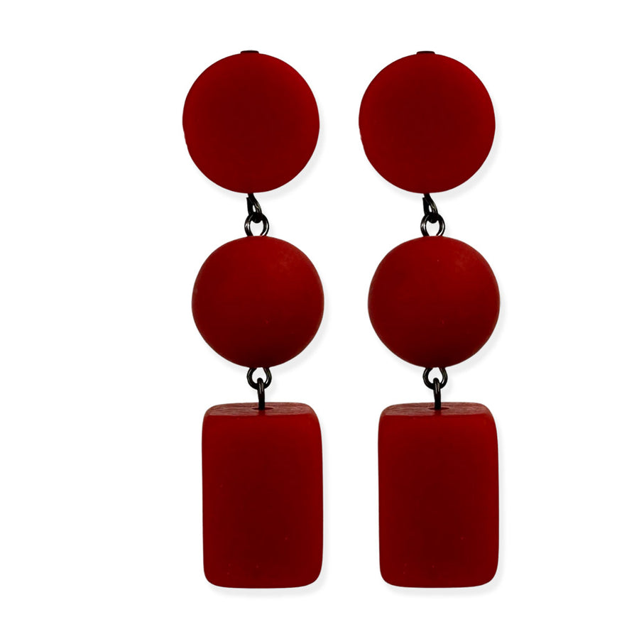 red dangling earrings on a white background