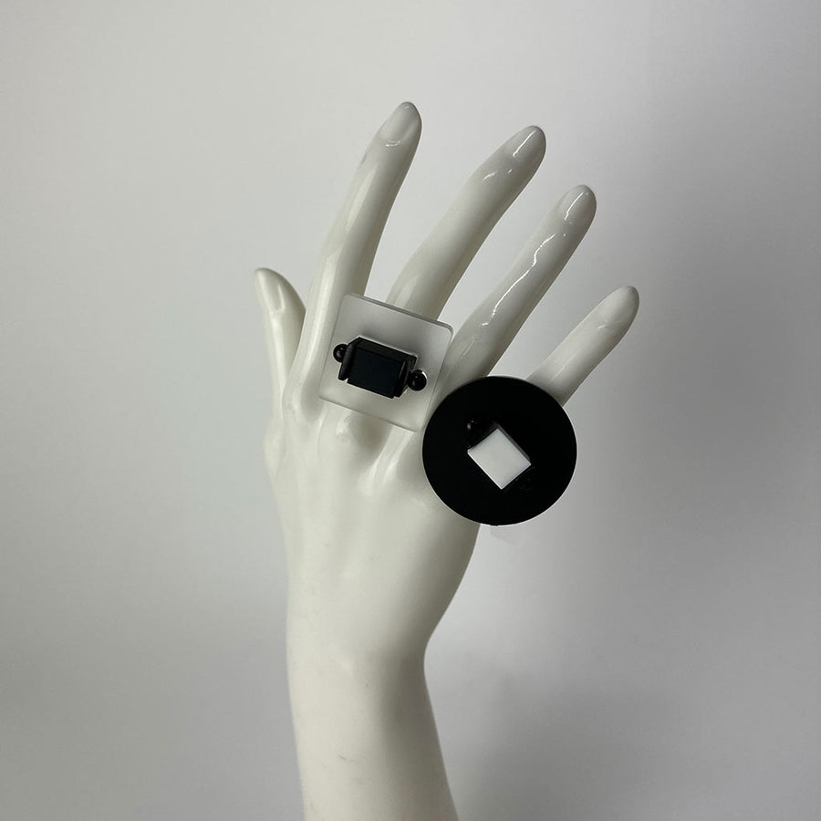 mannequin showing two chunky black and clear rings