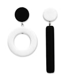 Asymmetrical black and white dot and dash earrings on a white background