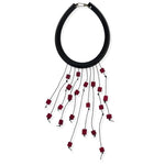 Statement necklace with red dangles on a white background