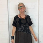 woman wearing a wooden pebble necklace