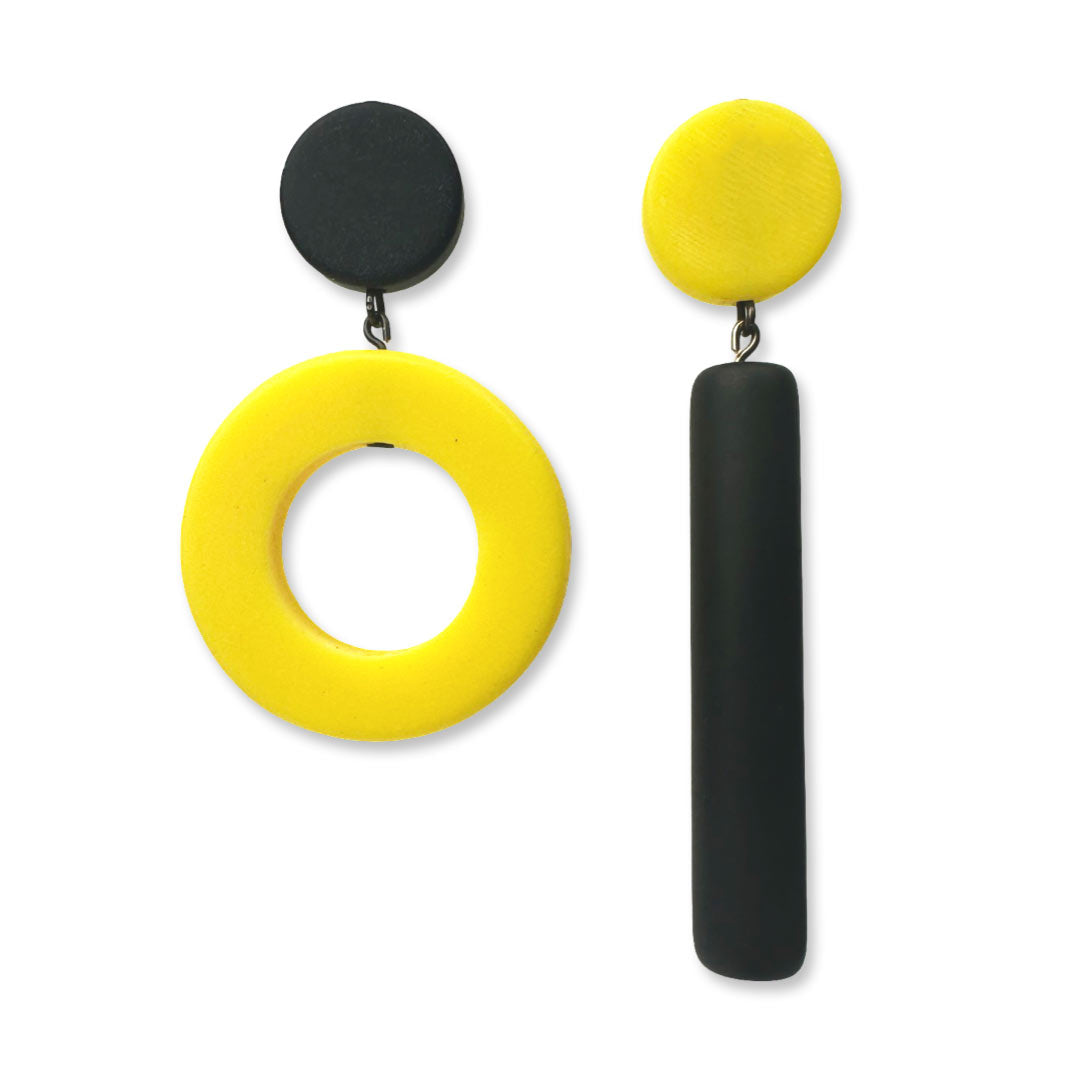 Asymmetrical black and yellow dot and dash earrings on a white background
