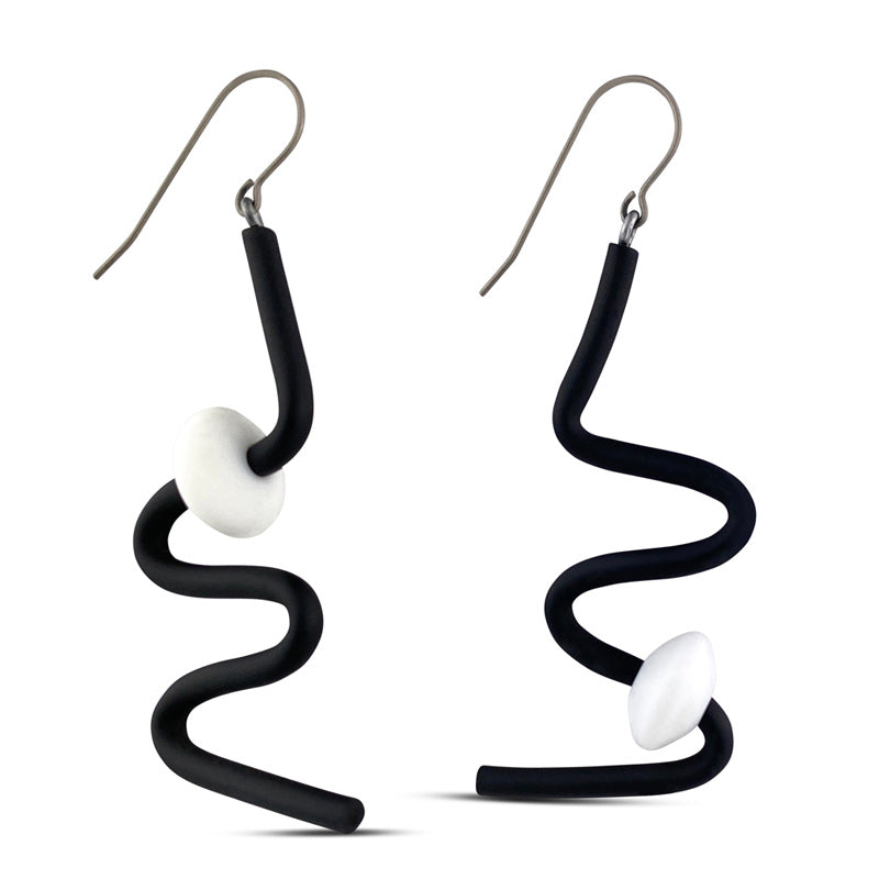 black squiggle earrings with white beads on a white background