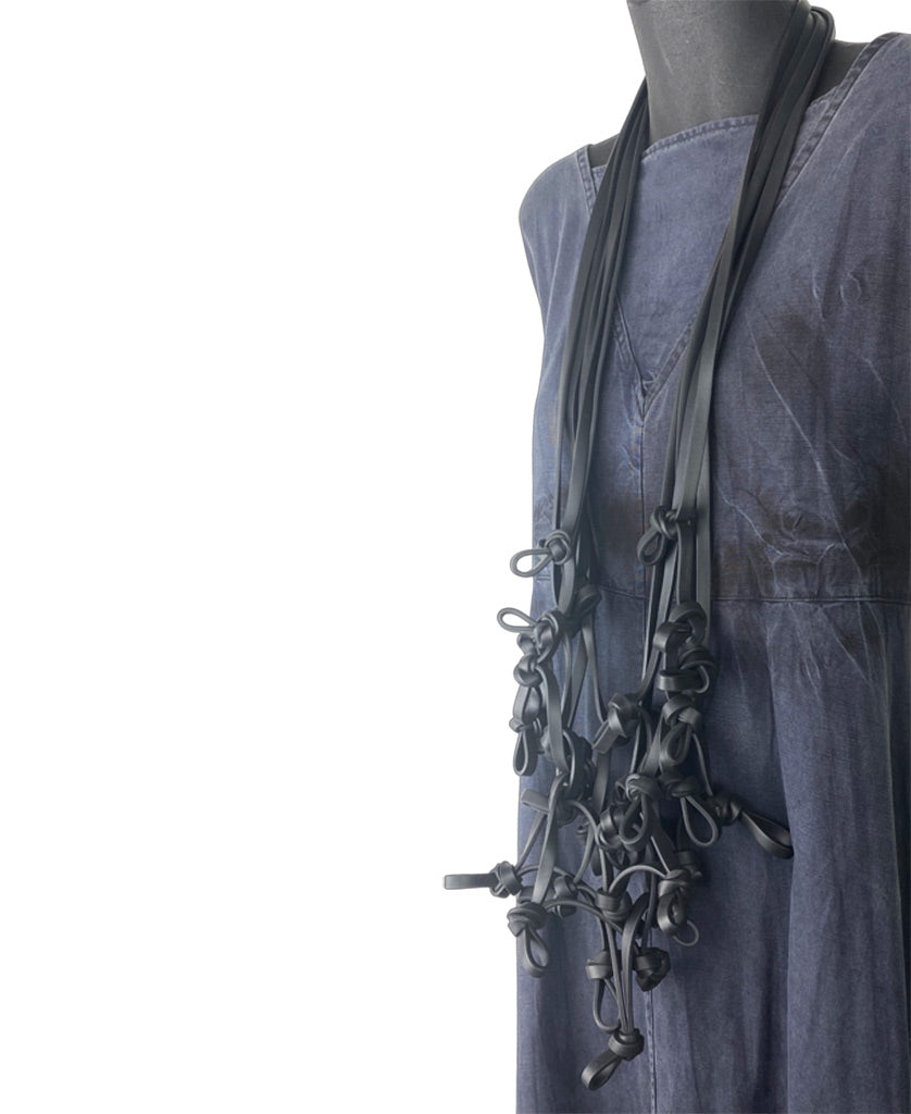 long black rubber necklace on a mannequin