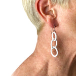 White Chain Earrings shown on a models ear