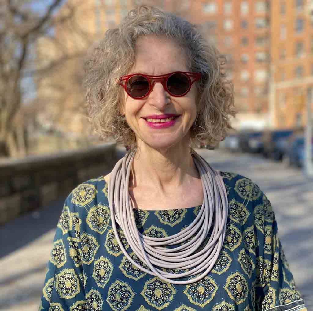 woman wearing a grey rubber necklace