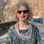woman wearing a grey rubber necklace