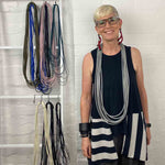 woman wearing a long grey rubber necklace