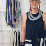 woman wearing a long grey rubber necklace